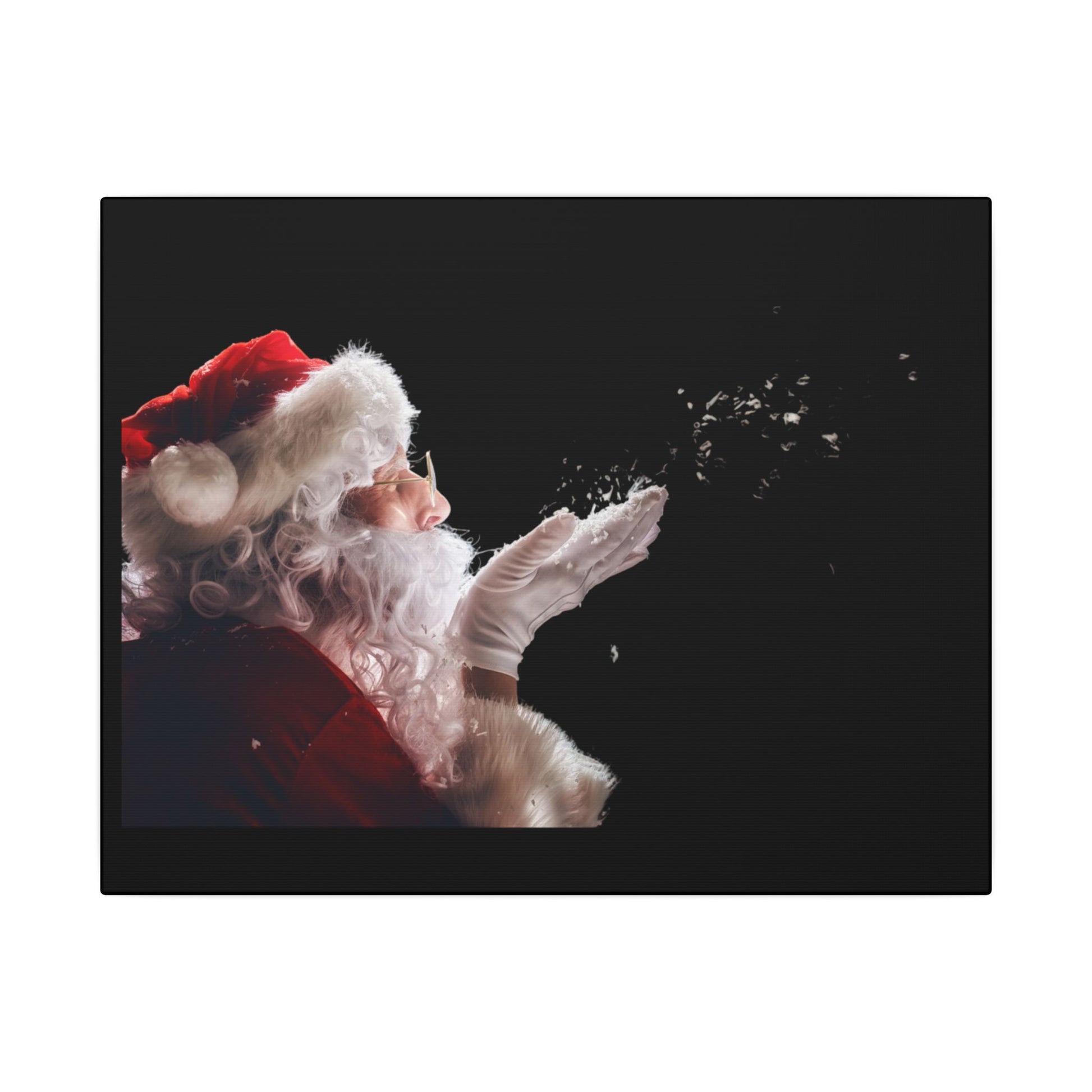 Santa Claus blowing snowflakes against a black background