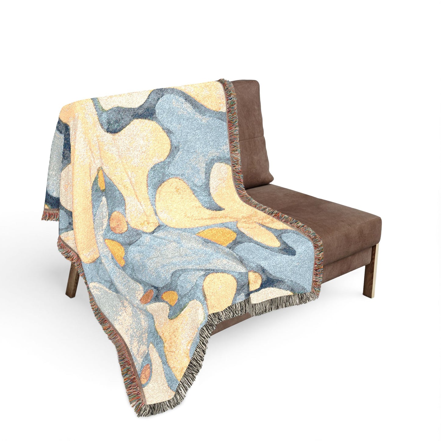 Decorative blanket with abstract pattern draped over a brown chair on a white background
