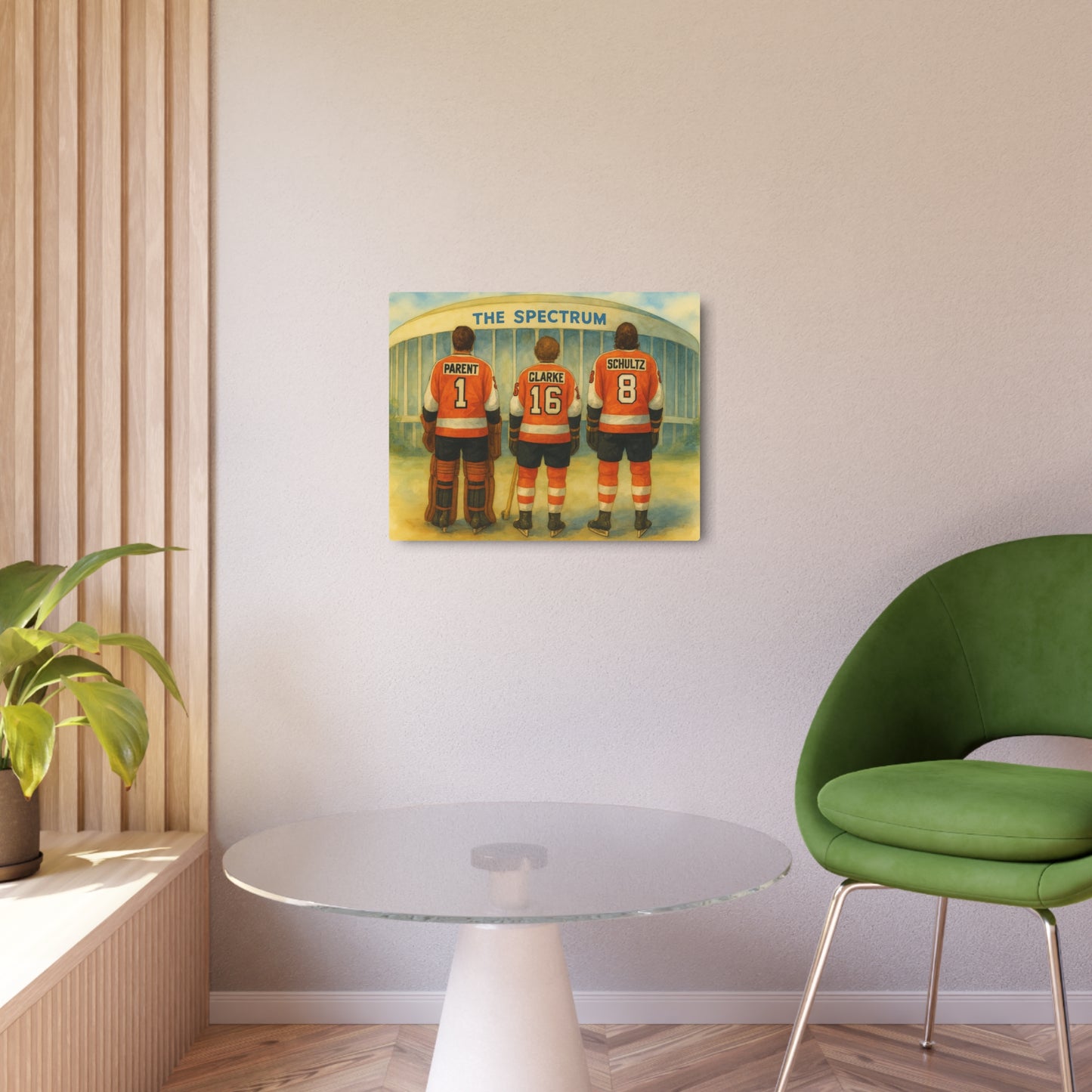 Poster of hockey players in orange jerseys on a wall above a glass table with a green chair.