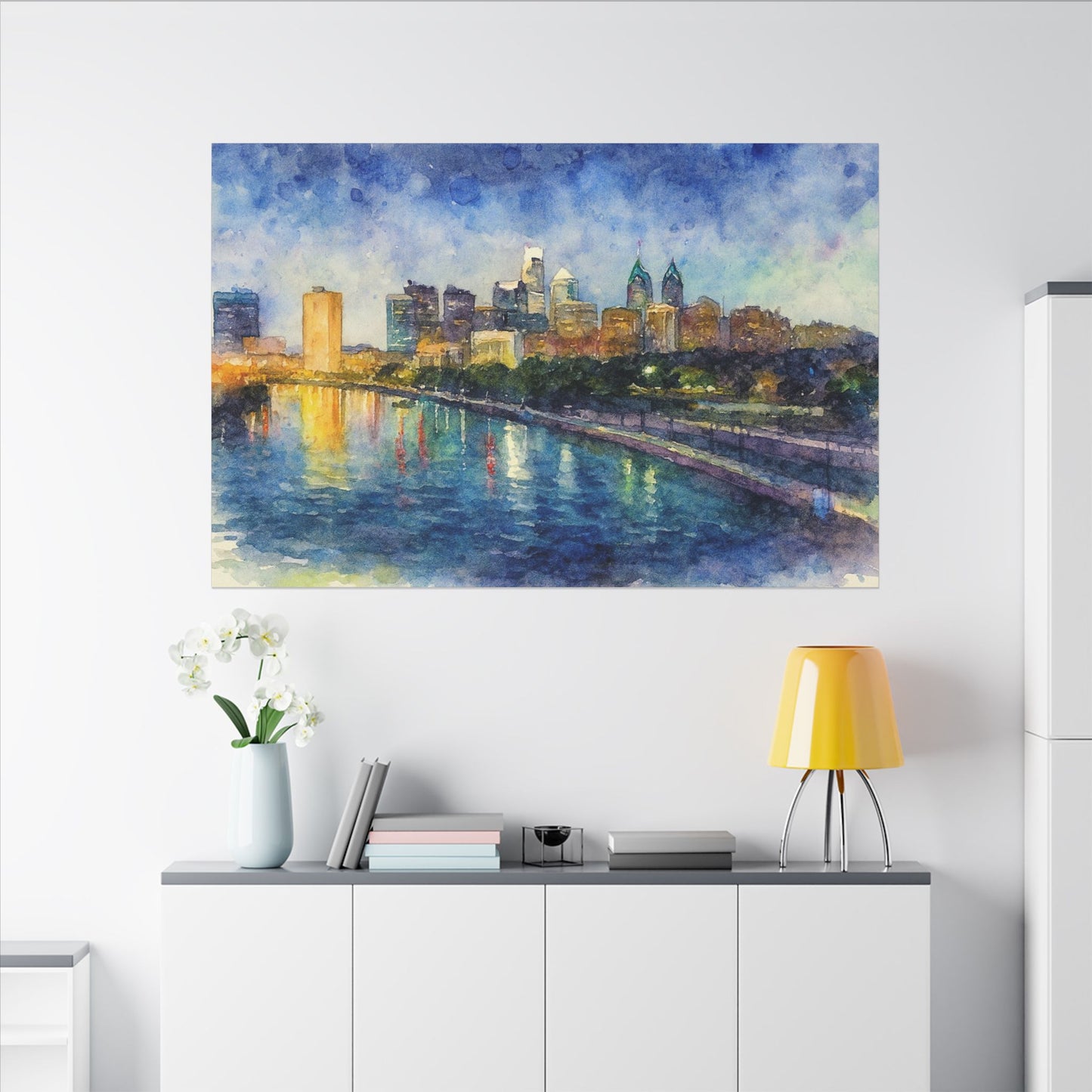 Cityscape painting on a wall above a white cabinet with a yellow lamp.