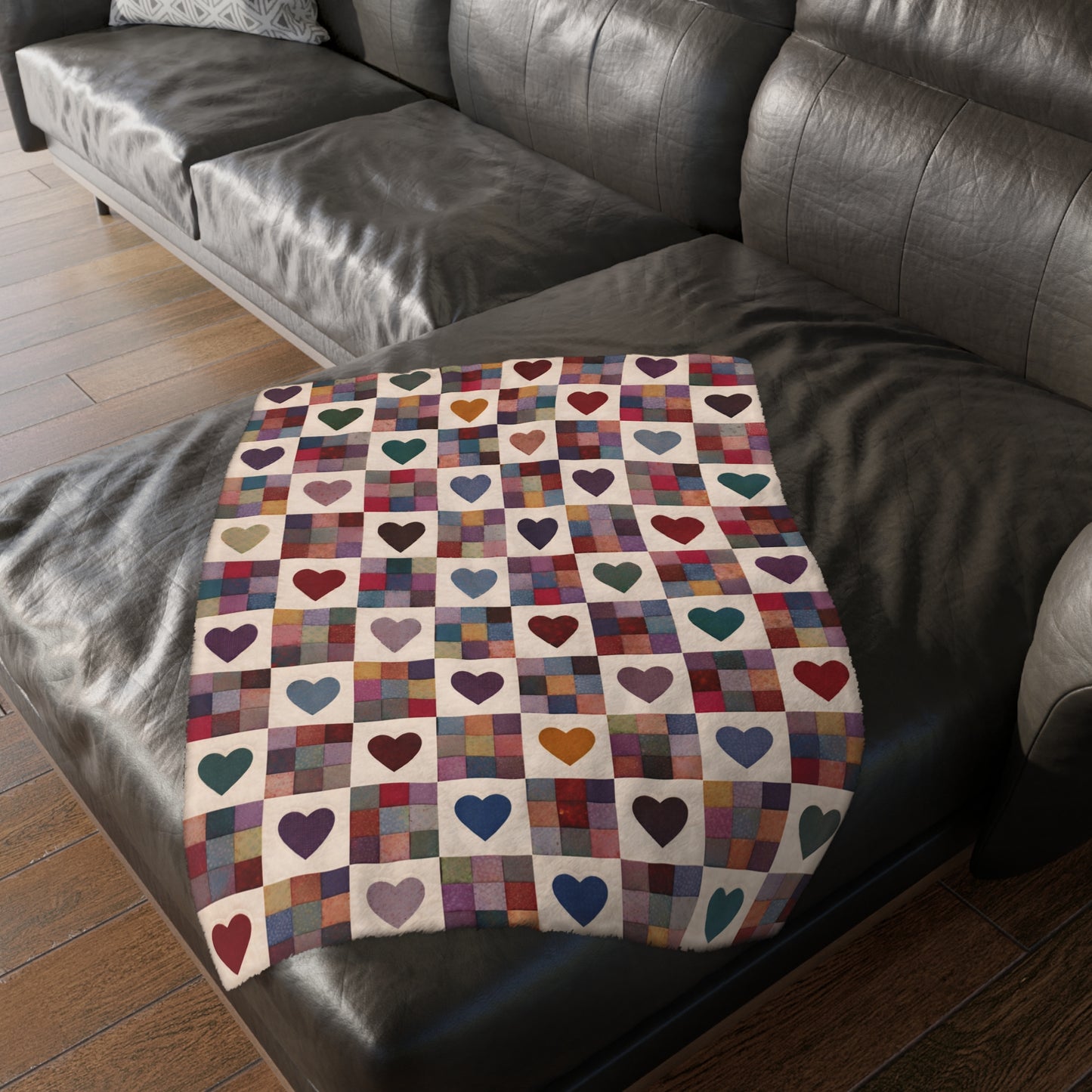Colorful throw with heart pattern draped over a dark brown sofa.