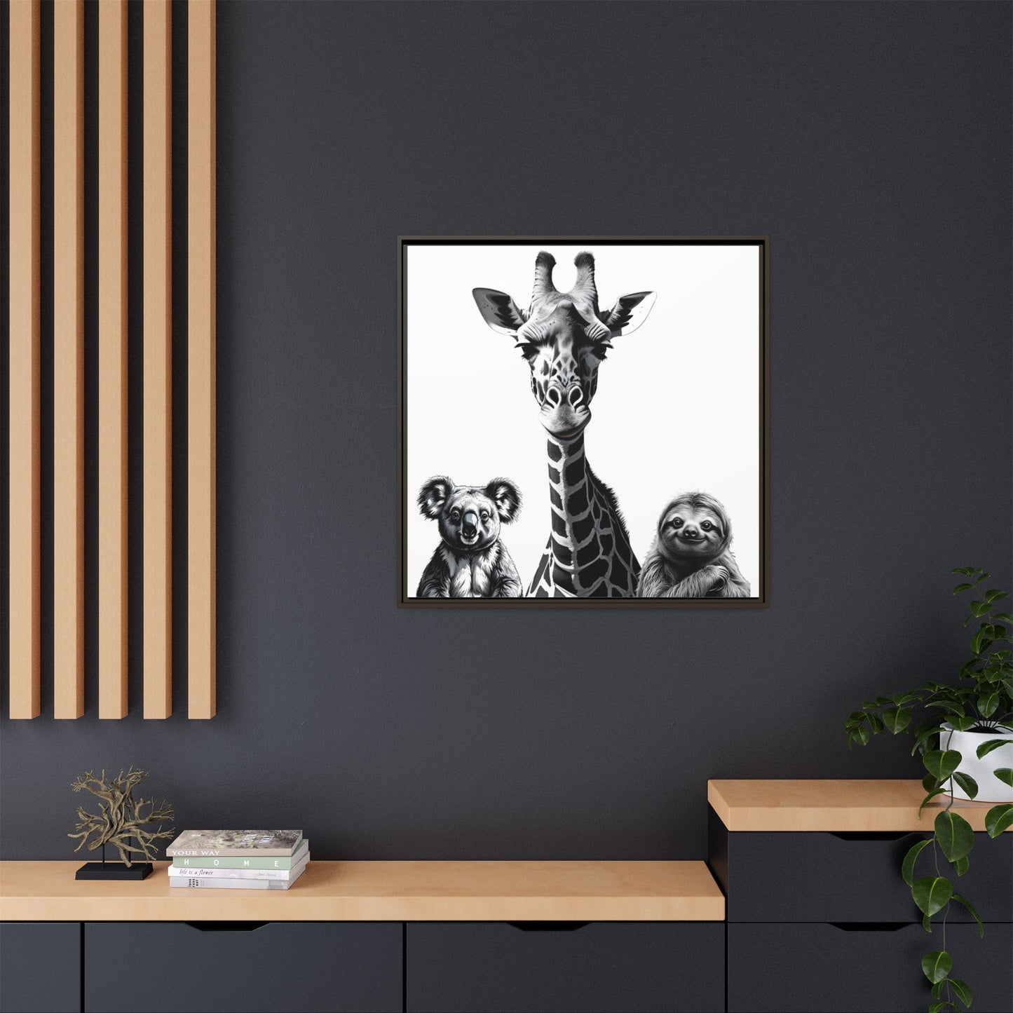 Framed artwork of a giraffe and two sloths on a dark wall with wooden shelves.
