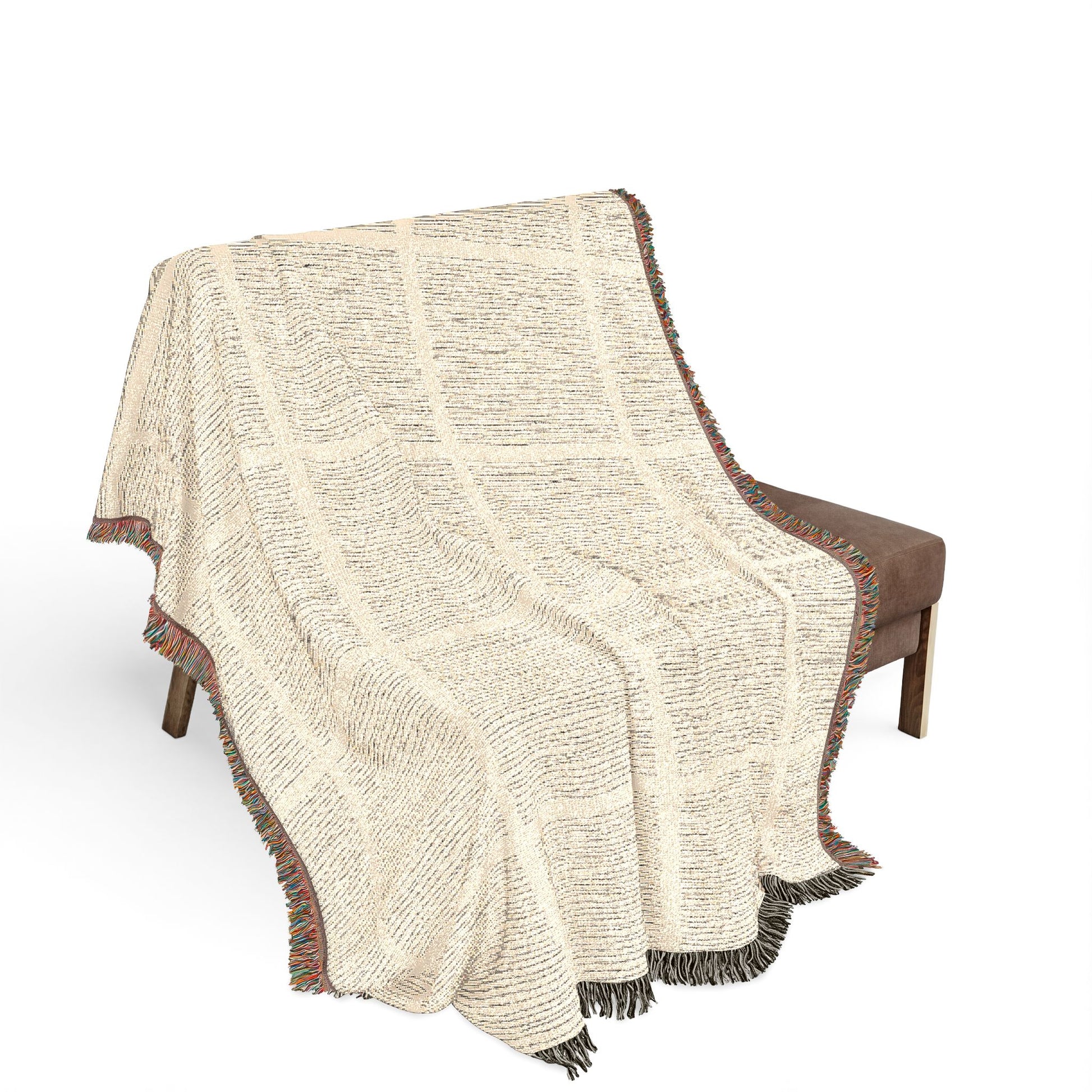 Beige textured throw blanket draped over a brown chair on a white background