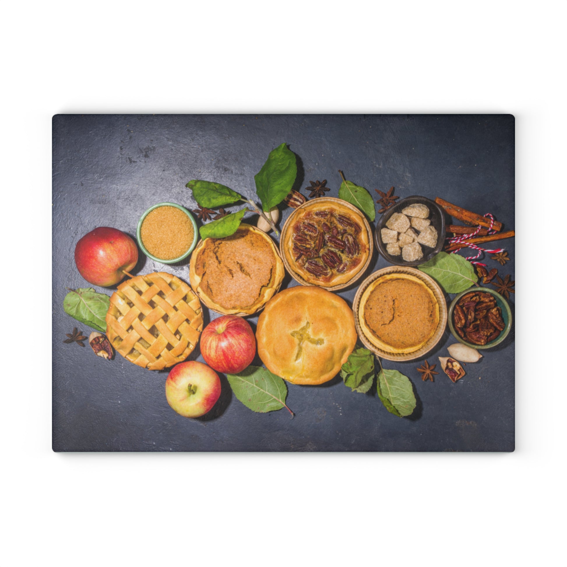 Decorative mat with pies, apples, and spices on a dark surface