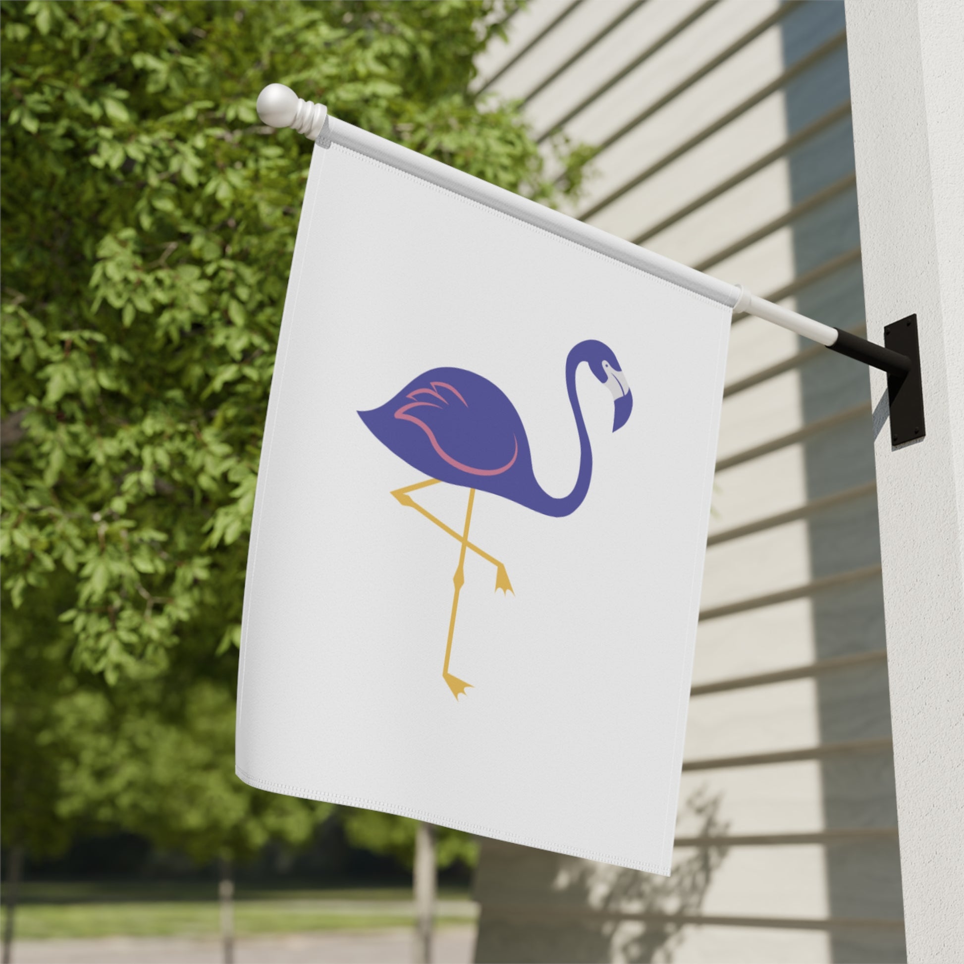 White flag with a purple flamingo design attached to a building exterior.