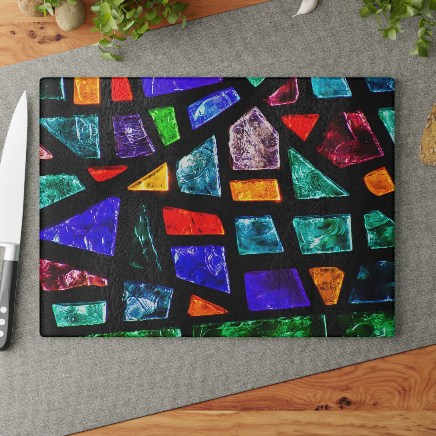 Colorful geometric patterned cutting board on a gray surface with a knife.