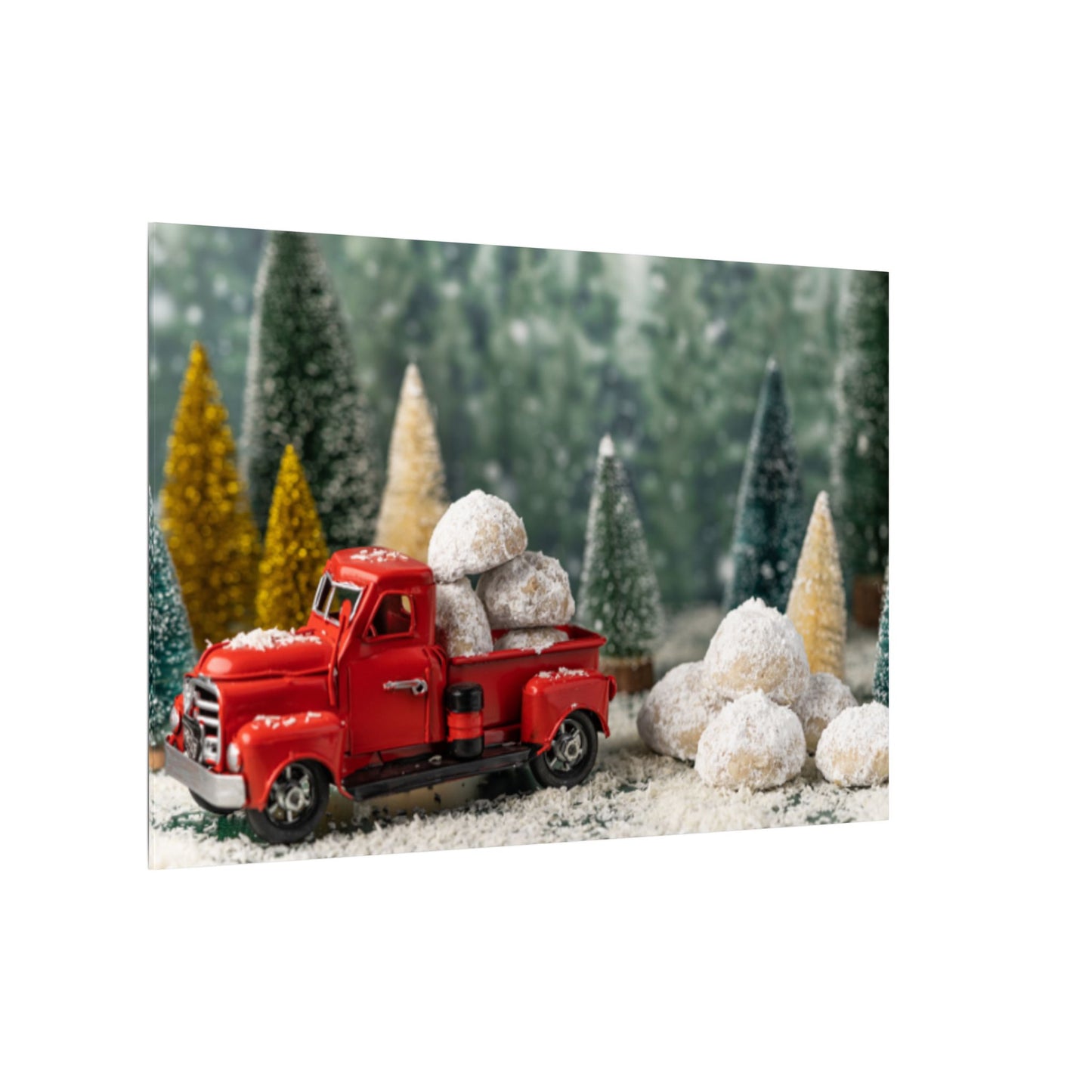 Red toy truck with snow-covered trees and rocks in a forest setting