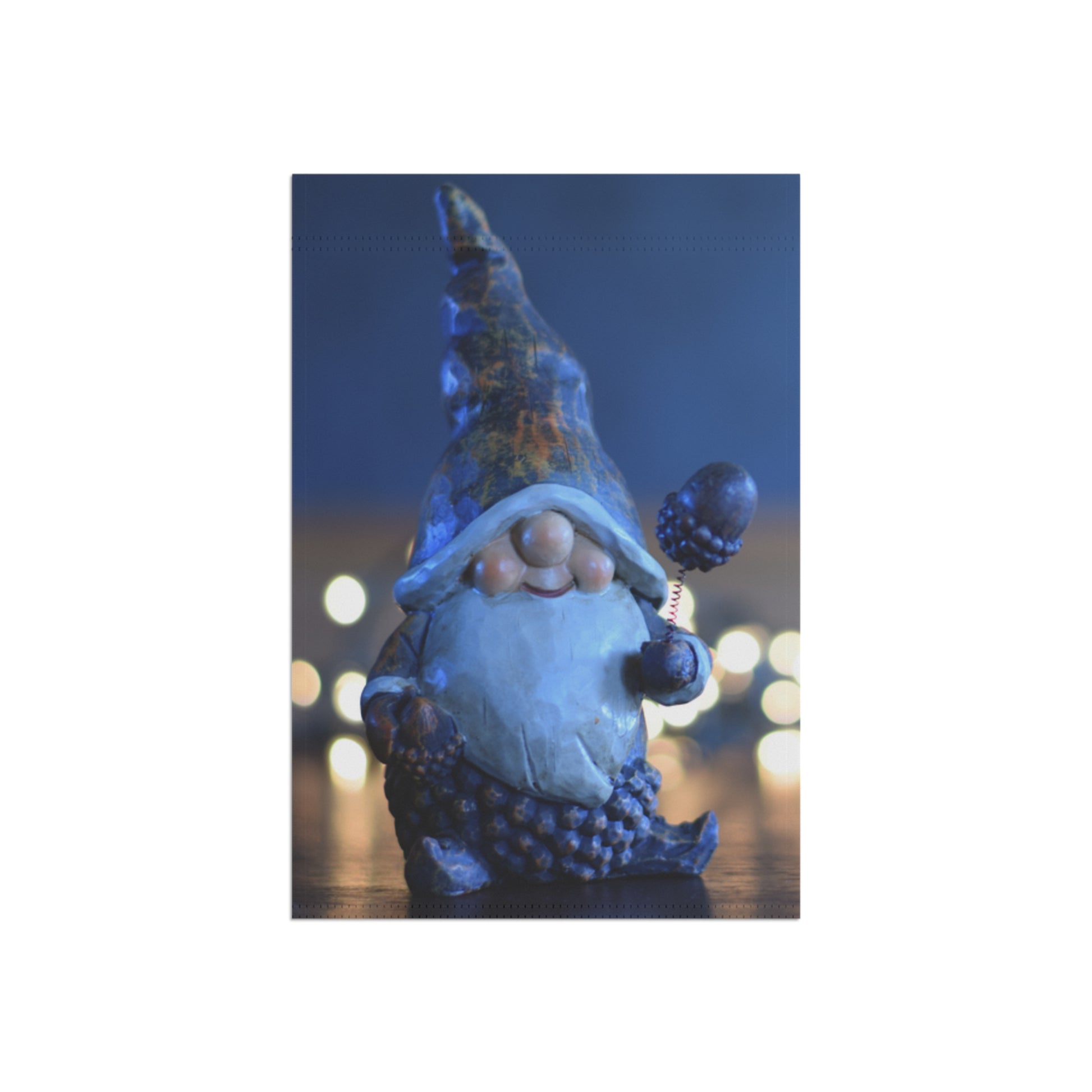 Decorative gnome figure with blue hat and beard against a blurred light background