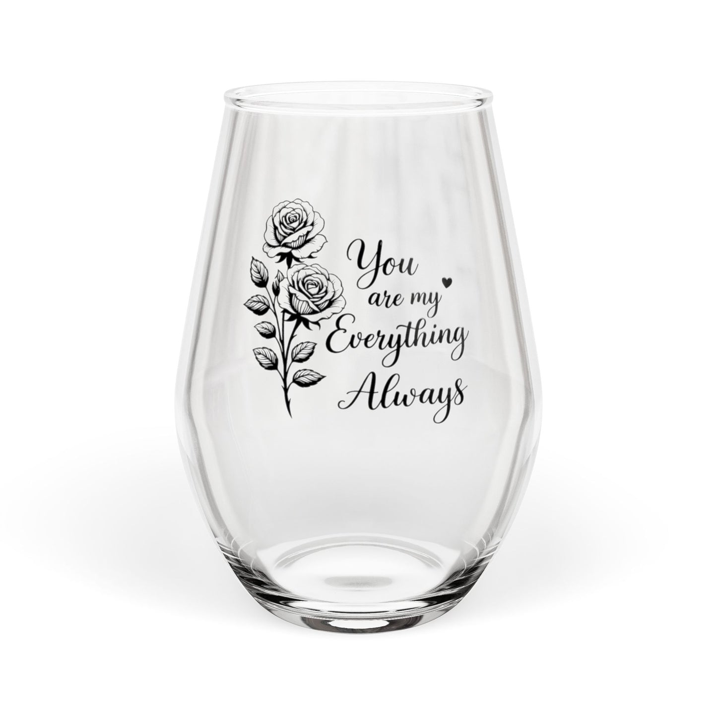 Clear glass wine glass with floral design and text on a white background