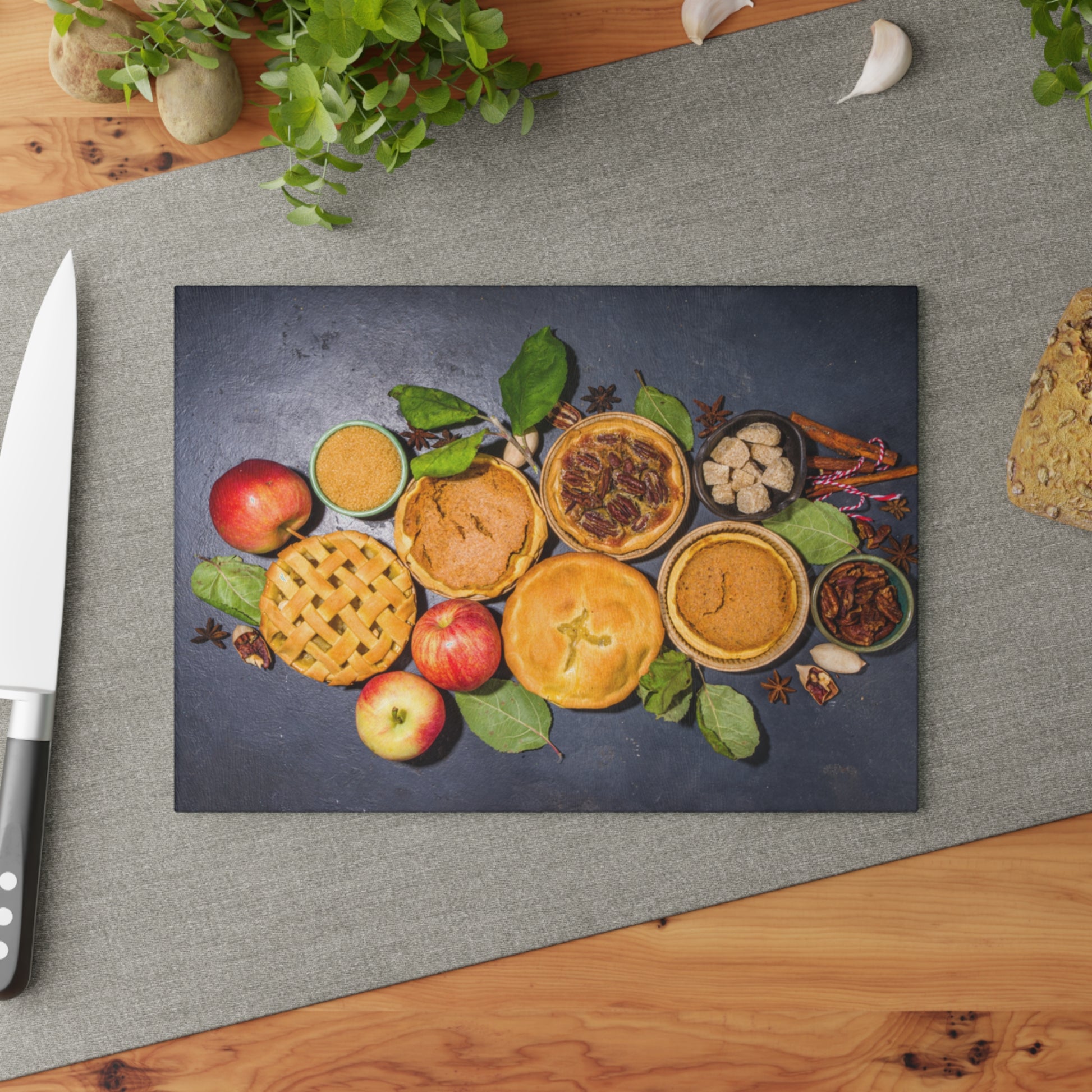 Decorative mat with pies and apples on a gray surface