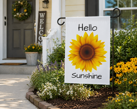 Decorative garden flag with sunflower and 'Hello Sunshine' text in front of a house.