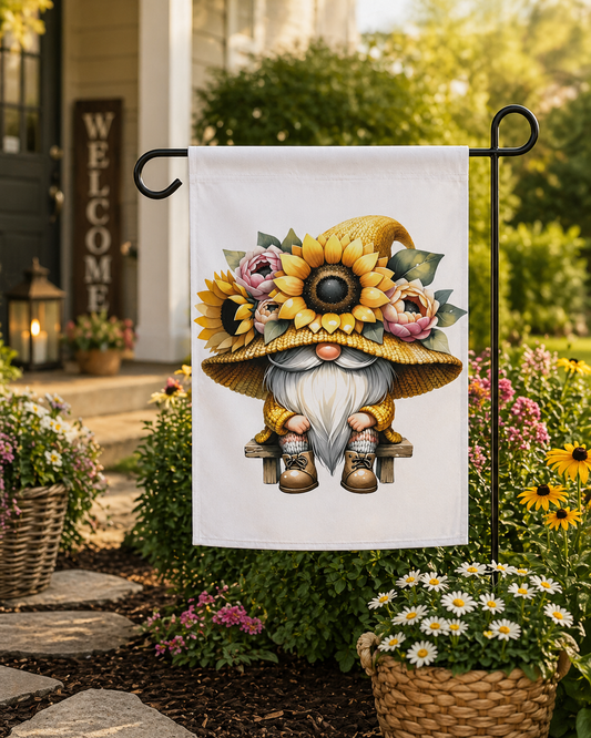 Decorative garden flag with a gnome wearing a sunflower hat in a garden setting.