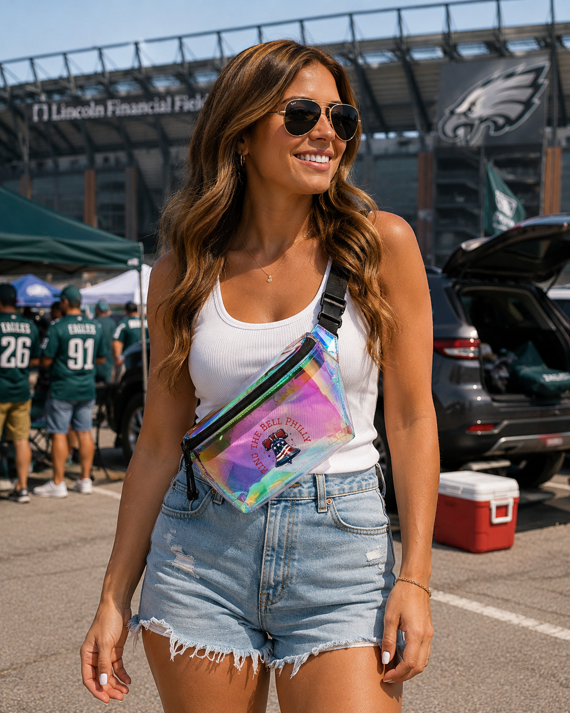 Woman holding a colorful bag in a parking lot with stadium in the background
