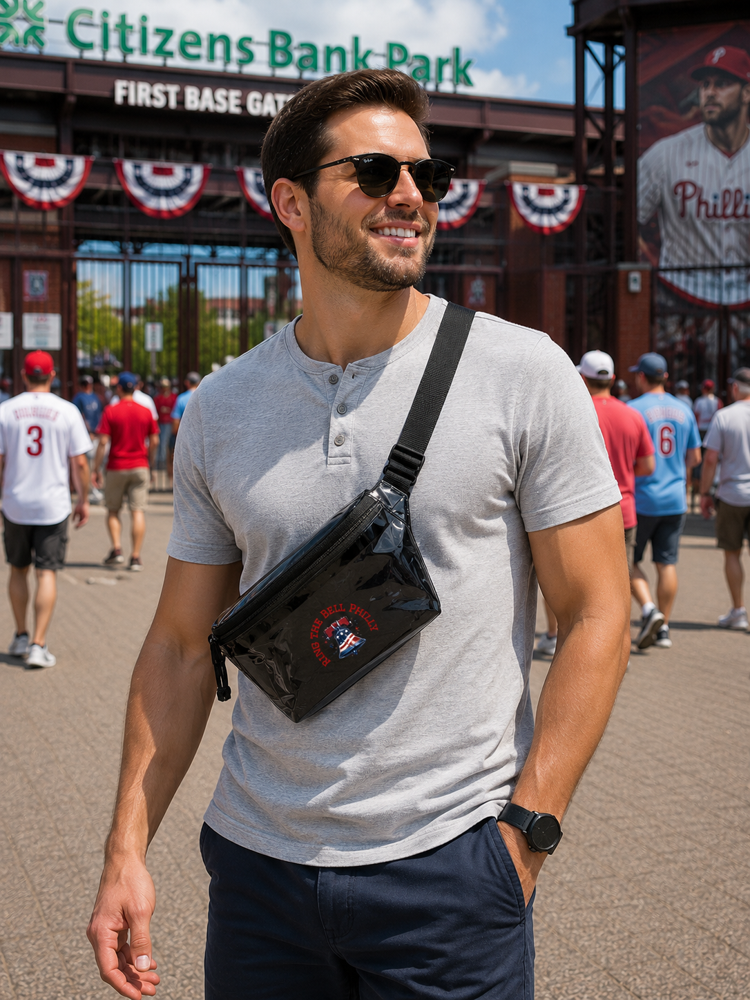 Man wearing sunglasses and a gray shirt with a black bag at Citizens Bank Park