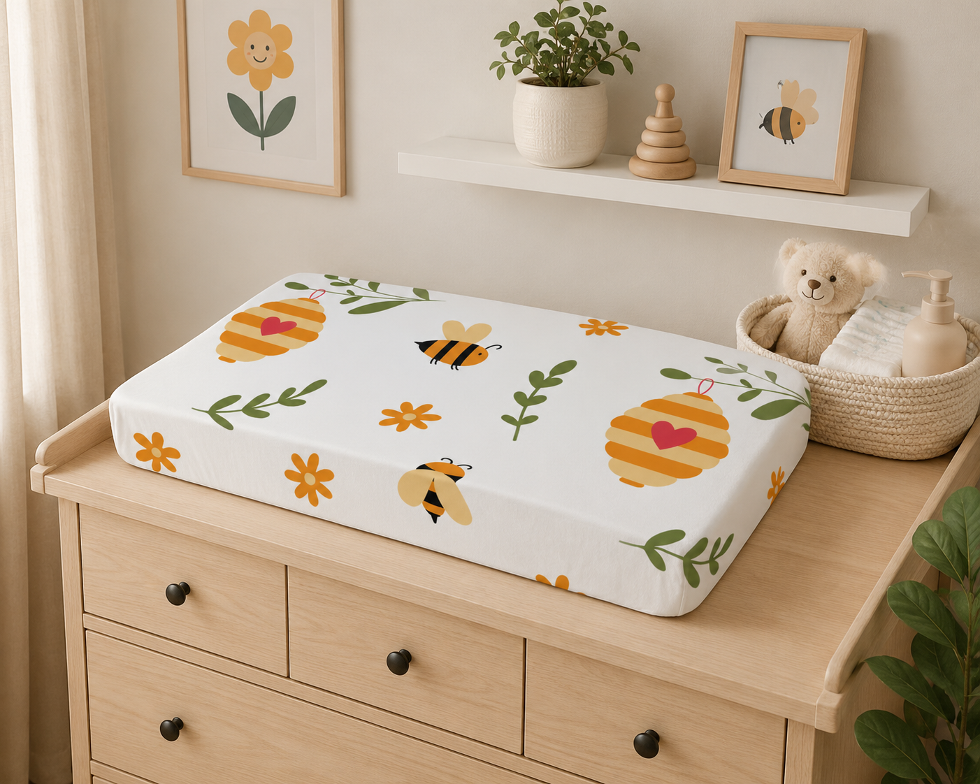 Changing table with a patterned cover on a wooden dresser in a nursery setting.