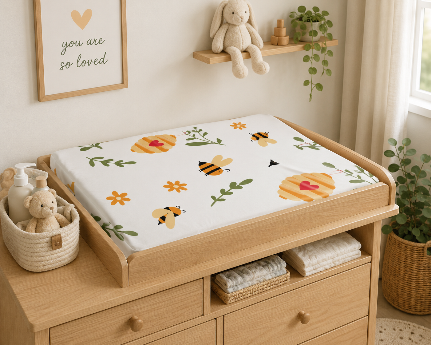 Wooden changing table with a floral-patterned cover in a nursery setting.