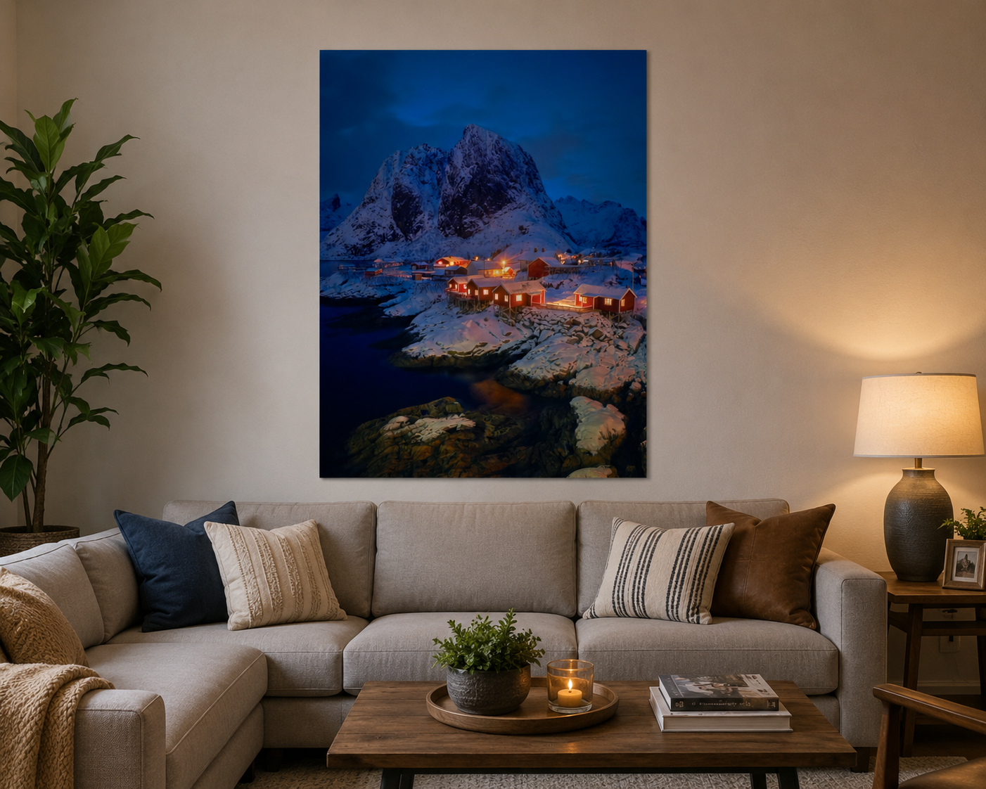 Snowy mountain landscape with illuminated buildings at night on living room wall
