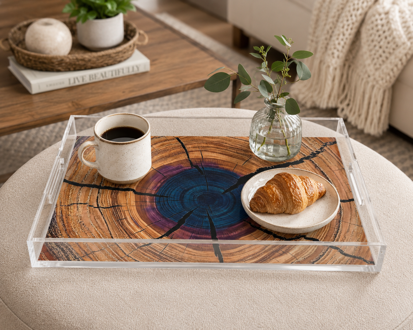 Clear acrylic tray with wooden design holding a cup of coffee and a croissant on a beige surface.